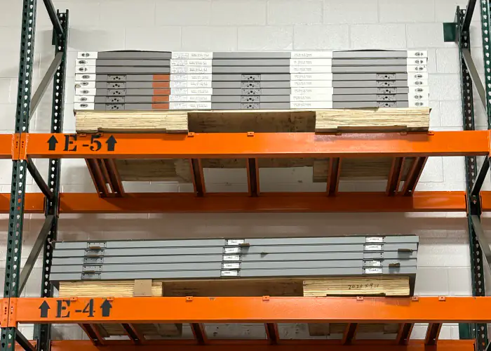 Commercial hollow metal doors stored on warehouse racks for material supply